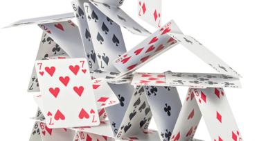 Main image showing a collapsing house of cards Main image showing a collapsing house of cards